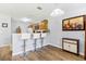 A kitchen featuring wood floors, a breakfast bar with seating, and wooden cabinets with updated appliances at 725 Cresting Oak Cir # 117, Orlando, FL 32824
