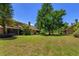 Spacious backyard featuring mature trees and ample green space at 7254 Della Dr, Orlando, FL 32819