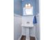 This bathroom features a pedestal sink, blue walls and white trim at 7254 Della Dr, Orlando, FL 32819