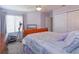 Bright bedroom with carpet, window, closet, ceiling fan and stationary exercise equipment for in-home workouts at 7254 Della Dr, Orlando, FL 32819