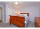 Cozy bedroom with carpet, wooden bed, ceiling fan, closet, and a dresser providing ample storage space at 7254 Della Dr, Orlando, FL 32819