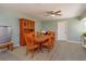 Cozy dining room featuring a wooden table, seating for six, and a hutch with glass doors, with a mini fridge nearby at 7254 Della Dr, Orlando, FL 32819
