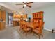 Open-concept dining area with wooden table, seating for six, and view of the kitchen with stainless steel appliances at 7254 Della Dr, Orlando, FL 32819
