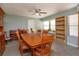 Bright dining area featuring a wooden table with seating for six, large windows, and built-in shelving at 7254 Della Dr, Orlando, FL 32819