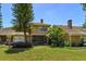 Charming home with mature trees and lush landscaping creating a serene outdoor space at 7254 Della Dr, Orlando, FL 32819