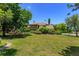 Well-manicured lawn with lush trees and landscaping surrounding the home at 7254 Della Dr, Orlando, FL 32819