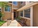 Charming front porch with a brick-paved walkway, cozy bench, and tasteful landscaping creates a welcoming entrance at 7254 Della Dr, Orlando, FL 32819