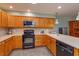 Well-equipped kitchen featuring stainless steel appliances, updated countertops, and classic wood cabinetry, with an efficient layout at 7254 Della Dr, Orlando, FL 32819
