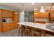 Spacious kitchen features wooden cabinets, large island with seating, stainless steel appliances and decorative lighting at 7254 Della Dr, Orlando, FL 32819