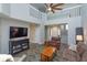 Spacious living room with soaring ceilings, a fan, wood floors, and comfortable seating at 7254 Della Dr, Orlando, FL 32819