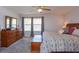 Bright, carpeted main bedroom with dresser, trunk, decorative lamps, and windows with bright natural light at 7254 Della Dr, Orlando, FL 32819