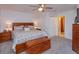 Well-lit main bedroom with a wooden bed frame, nightstands, a decorative chest, and closet space at 7254 Della Dr, Orlando, FL 32819