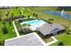 Aerial view of a community pool, clubhouse, parking area, and green space at 9040 Alba Ln, Kissimmee, FL 34747