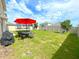 Spacious backyard featuring green lawn, outdoor furniture, a trampoline and a swing set at 9040 Alba Ln, Kissimmee, FL 34747