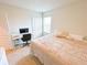 Bedroom with a cozy bed, work station, and ample natural light for study or relaxation at 9040 Alba Ln, Kissimmee, FL 34747