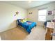 Brightly lit carpeted bedroom with a full size bed and a window at 9040 Alba Ln, Kissimmee, FL 34747
