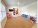 Cozy carpeted room with bookshelves and neutral walls, perfect for playtime or relaxation at 9040 Alba Ln, Kissimmee, FL 34747
