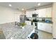 Bright kitchen with white cabinets, granite countertops, and stainless steel appliances at 9040 Alba Ln, Kissimmee, FL 34747