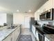 Bright kitchen with white cabinets, stainless steel appliances, and granite countertops at 9040 Alba Ln, Kissimmee, FL 34747