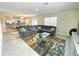 Open-concept living space with a gray sectional and view into the kitchen at 9040 Alba Ln, Kissimmee, FL 34747