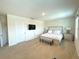 Spacious main bedroom with a king bed, carpet flooring, and white bedding at 9040 Alba Ln, Kissimmee, FL 34747
