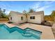 Charming backyard with a refreshing pool featuring integrated steps, complemented by palm trees and a well-maintained exterior at 9345 Buttonwood St, Orlando, FL 32825