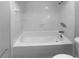 Clean bathroom with a tiled shower-over-bath including shower head and controls at 9345 Buttonwood St, Orlando, FL 32825