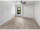 Cozy bedroom with neutral carpet, a ceiling fan, and a view of the backyard landscape through a window at 9345 Buttonwood St, Orlando, FL 32825