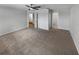 Large bedroom with plush carpet, ceiling fan, and multiple doorways allowing access to en-suite bath at 9345 Buttonwood St, Orlando, FL 32825