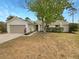 Charming single-story home with a stone accent facade, attached garage, and a well-maintained front yard at 9345 Buttonwood St, Orlando, FL 32825