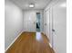 Inviting hallway featuring hardwood floors, a bright white front door, and neutral walls, creating a welcoming entrance at 9345 Buttonwood St, Orlando, FL 32825