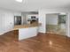 Open-concept kitchen featuring stainless steel appliances, peninsula, and open access to the living room at 9345 Buttonwood St, Orlando, FL 32825