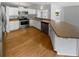 Bright kitchen with white cabinets, stainless steel appliances, and wood flooring at 9345 Buttonwood St, Orlando, FL 32825