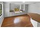 Bright, remodeled kitchen with white cabinets, laminate counters, wood flooring and a breakfast bar at 9345 Buttonwood St, Orlando, FL 32825