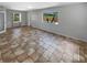 Spacious living room with neutral walls, tile flooring, and built-in shelving and a view of the pool at 9345 Buttonwood St, Orlando, FL 32825
