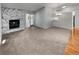 Spacious living room showcases a stone fireplace, a combination of hardwood and carpeted floors, and neutral walls at 9345 Buttonwood St, Orlando, FL 32825