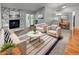 Cozy living room features a stone fireplace, modern furnishings, and natural light from the sliding glass door at 9345 Buttonwood St, Orlando, FL 32825