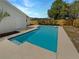 Inviting backyard pool featuring a serene blue hue, complemented by a concrete surround, ideal for leisurely swims and relaxation at 9345 Buttonwood St, Orlando, FL 32825