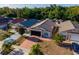 Aerial view of a charming home with a two-car garage, well-maintained landscaping, and a spacious driveway at 9911 Dean Cove Ln, Orlando, FL 32825