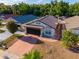 Aerial view of a charming home with a two-car garage, well-maintained landscaping, and a spacious driveway at 9911 Dean Cove Ln, Orlando, FL 32825