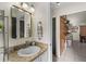 Bathroom featuring granite countertops, updated fixtures, and an attractive framed mirror at 9911 Dean Cove Ln, Orlando, FL 32825