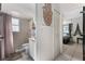 Bathroom with tiled shower, neutral shower curtain, and access to the bedroom at 9911 Dean Cove Ln, Orlando, FL 32825