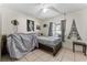 Bedroom with tile flooring, ceiling fan, decorative wall art, and a bright window with gray curtains at 9911 Dean Cove Ln, Orlando, FL 32825