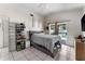 Brightly lit bedroom featuring tile floors, a ceiling fan, and a sliding glass door to the backyard at 9911 Dean Cove Ln, Orlando, FL 32825