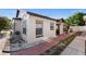 Charming home exterior with well-maintained landscaping, brick accents, and inviting entryway, set against a blue sky at 9911 Dean Cove Ln, Orlando, FL 32825