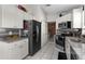 Modern kitchen features white cabinets, stainless steel appliances, and ample storage space at 9911 Dean Cove Ln, Orlando, FL 32825