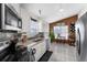 Bright kitchen featuring stainless steel appliances, granite countertops, and tile flooring at 9911 Dean Cove Ln, Orlando, FL 32825