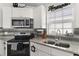 Updated kitchen with granite countertops, stainless steel appliances, and recessed lighting at 9911 Dean Cove Ln, Orlando, FL 32825