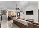 Comfortable living room features tile flooring, a ceiling fan, and a wall-mounted TV at 9911 Dean Cove Ln, Orlando, FL 32825
