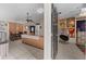 Open-concept living room featuring tile floors, ceiling fan, and dining area near the hallway at 9911 Dean Cove Ln, Orlando, FL 32825